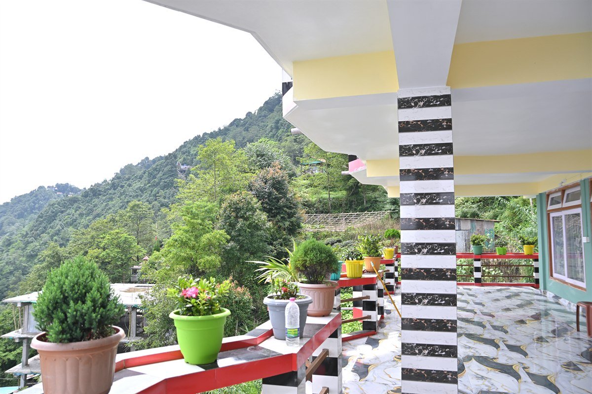 Dawaipani – Balcony with Flower Pots and Valley Views